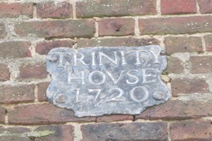 Wall sign reading Trinity Hovse 